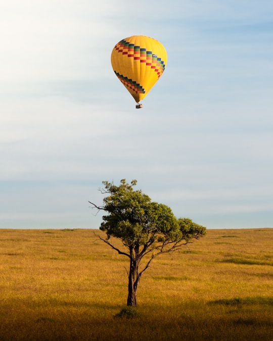 yellow and red hot air balloon in the sky in Maasai Mara National Reserve Kenya