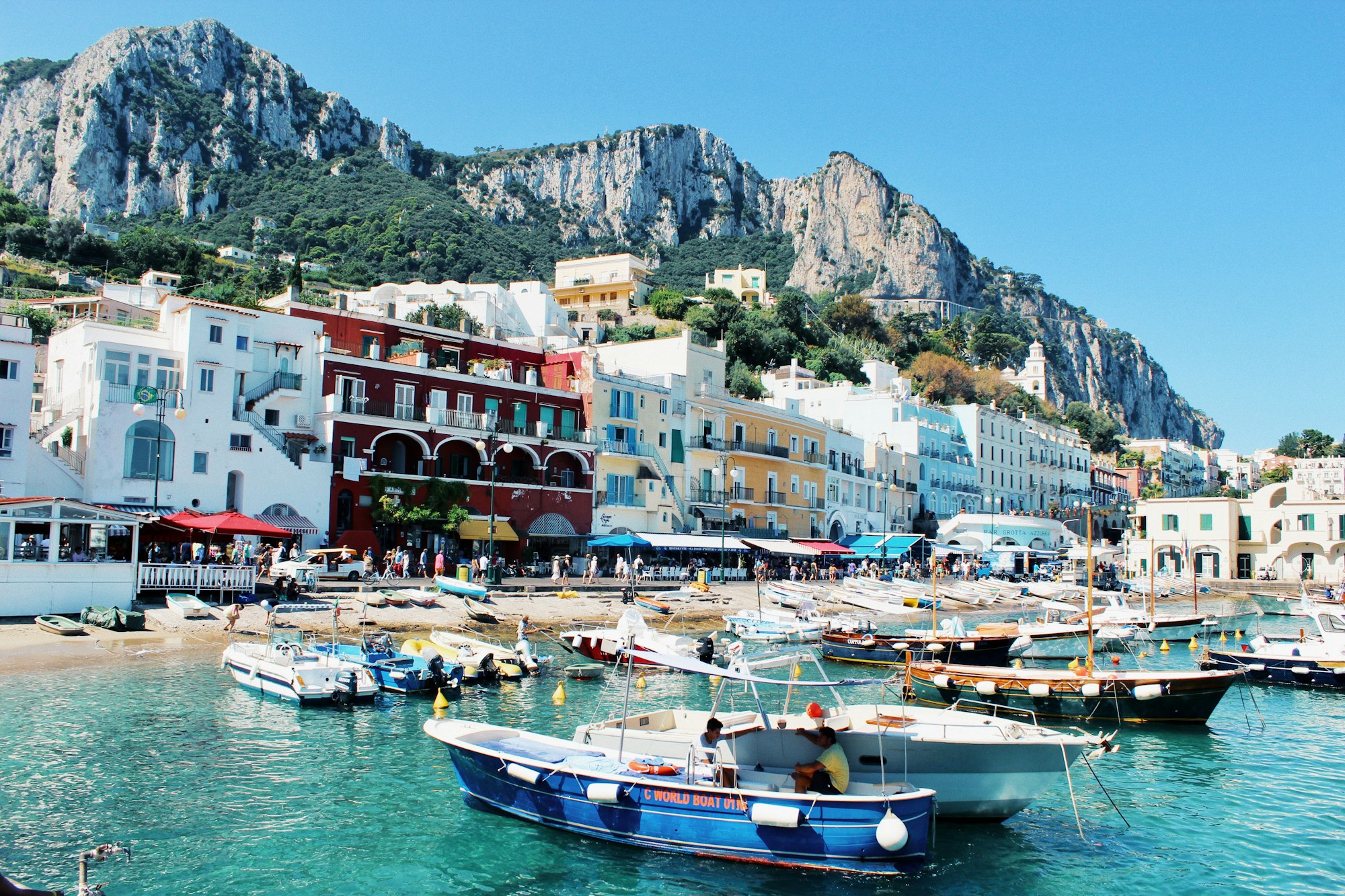 Pulling into the harbour at Capri. Bold colours of turquoise seas and contrasting boats and buildings galore.