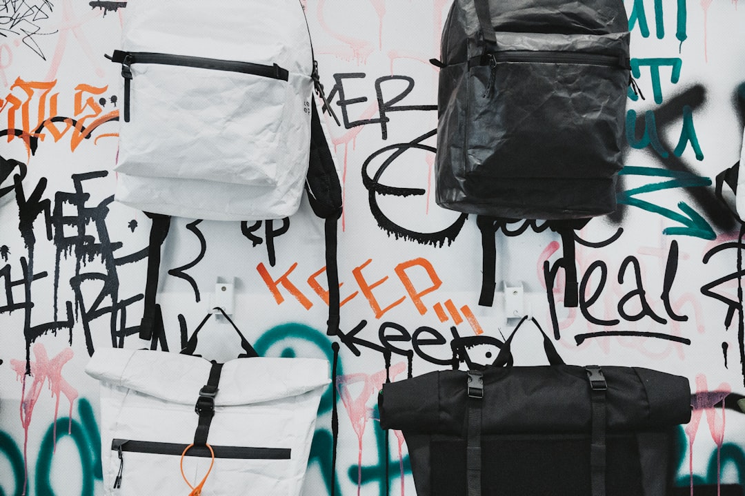 black and gray backpack on white and blue textile