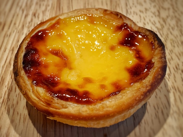 Artisan tart with a golden crust and rich, creamy filling, photographed with soft natural light.