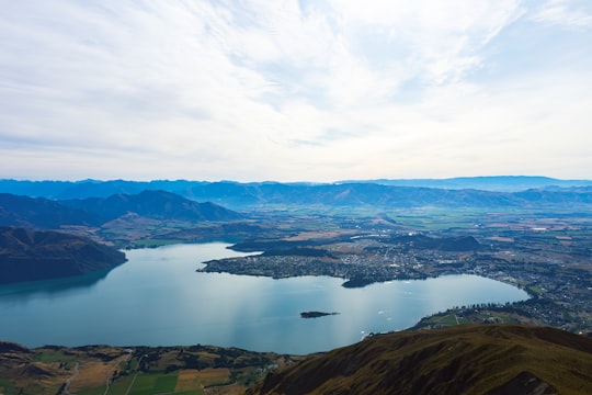 aerial view of lake and mountains during daytime in Roys Peak New Zealand