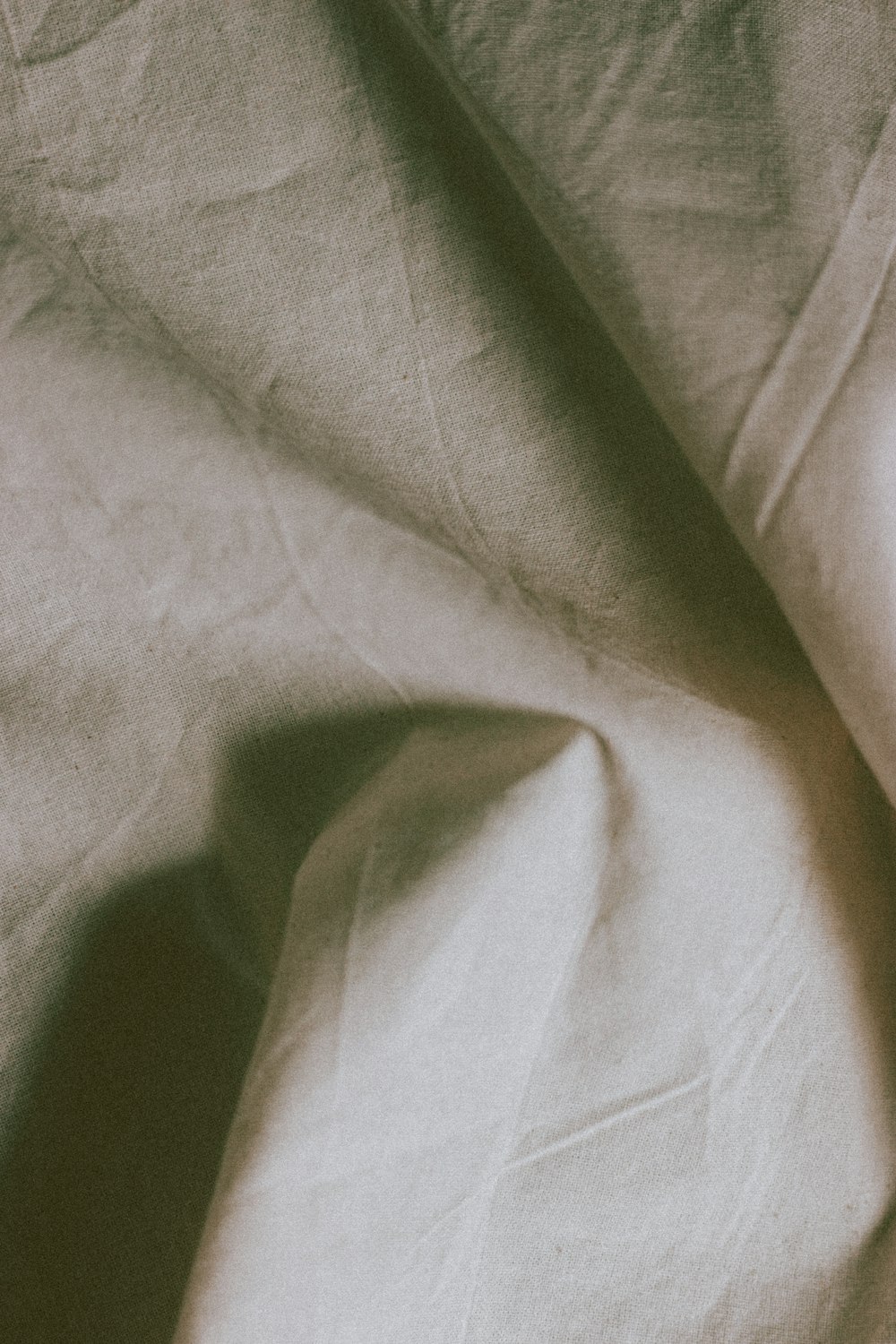 white textile on brown wooden table