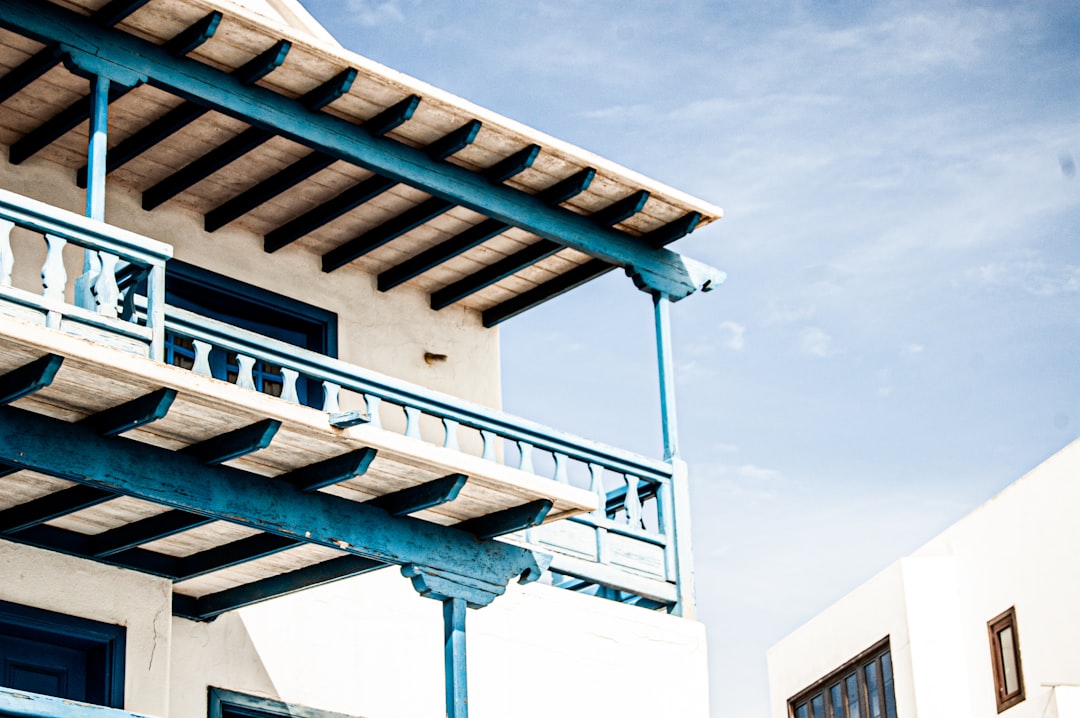 white and brown concrete building under white clouds during daytime