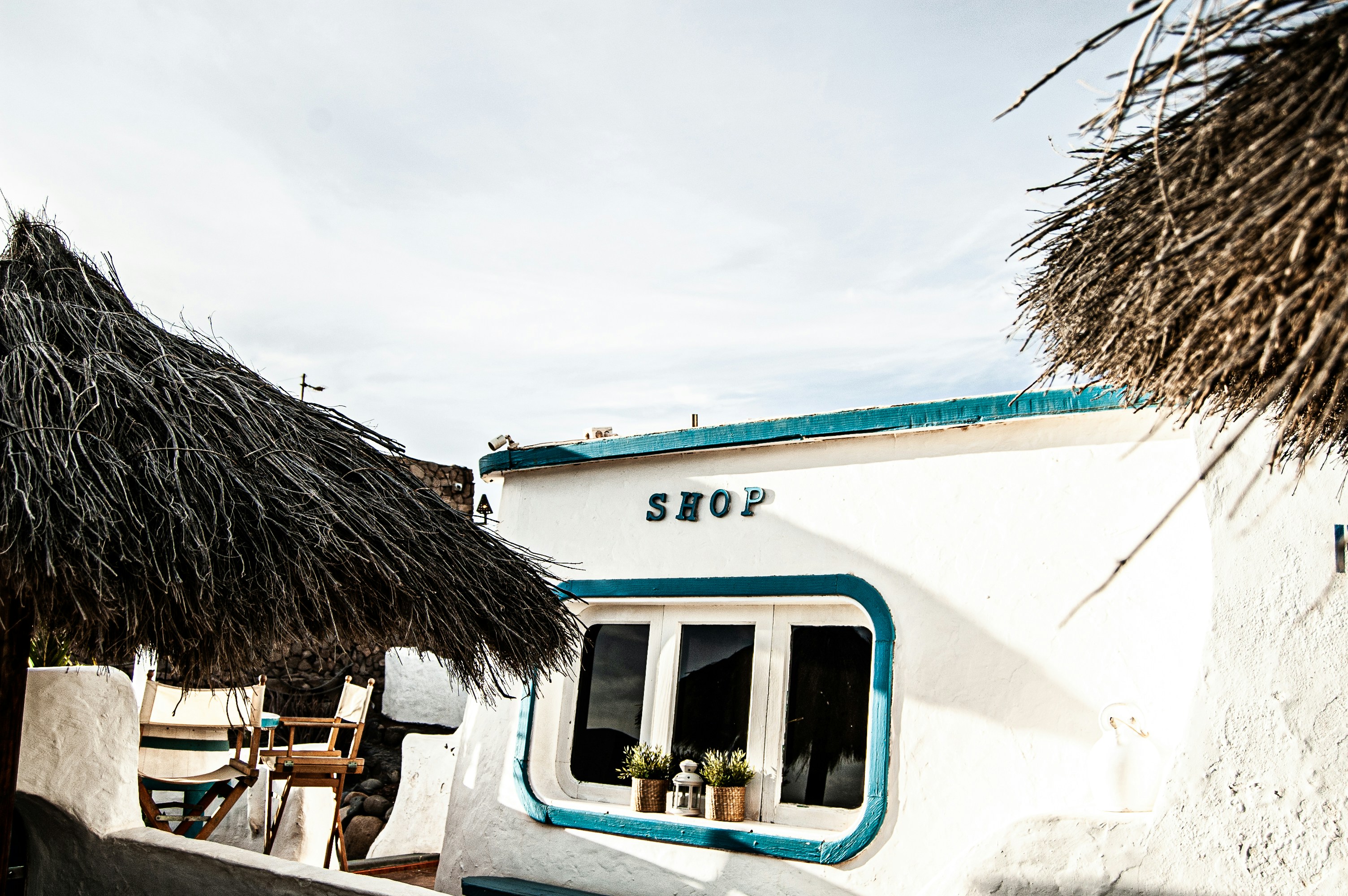 blue and white wooden house under white clouds during daytime