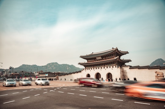 cars parked near brown and white building during daytime in Gwanghwamun Gate South Korea