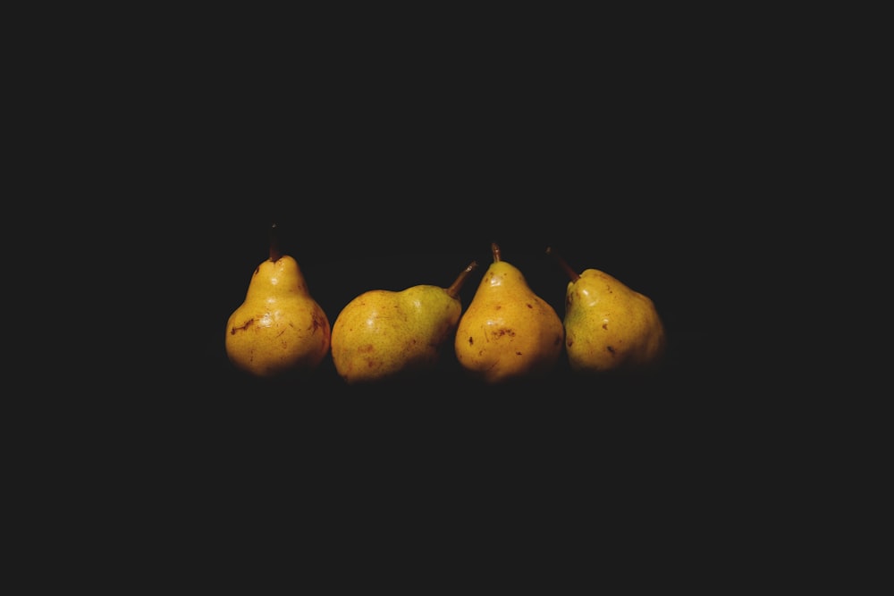 3 yellow fruit with black background