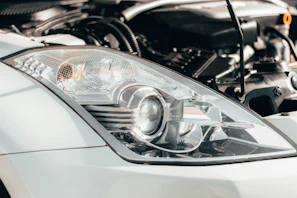 grey car with headlight turned on in grayscale photography