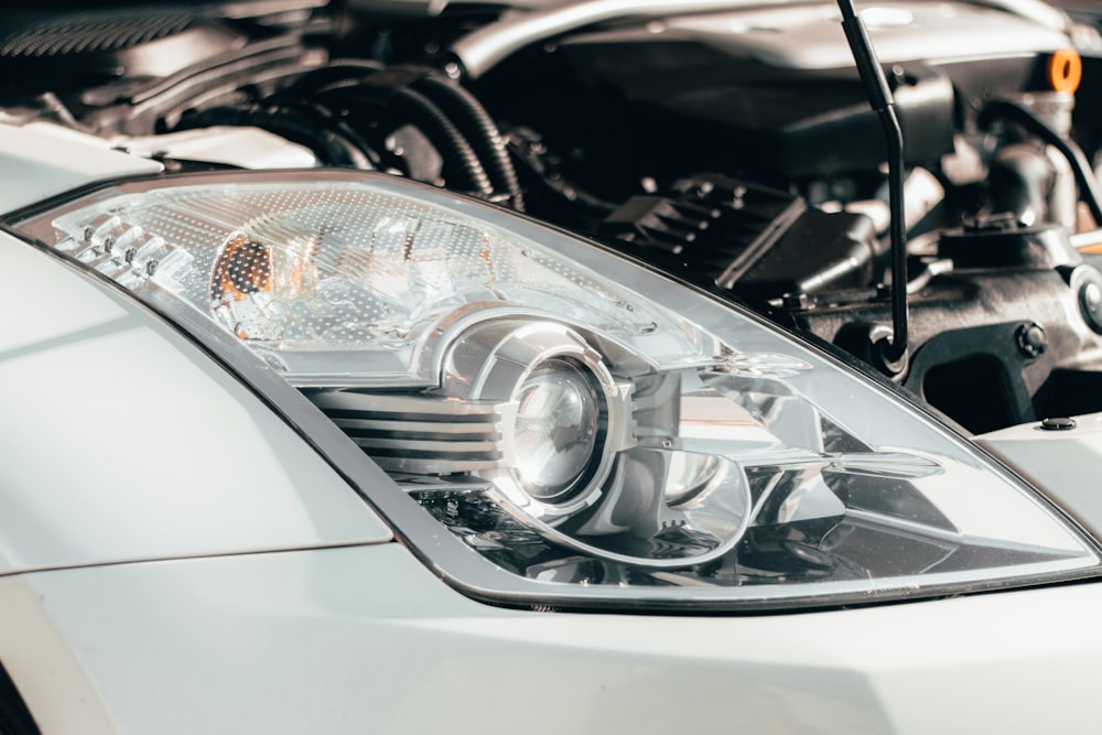 grey car with headlight turned on in grayscale photography