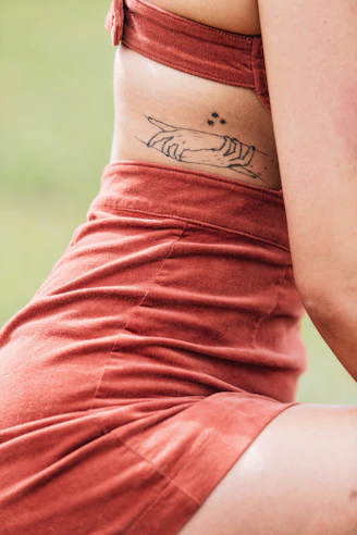Minimalist black color tattoo on a girl back