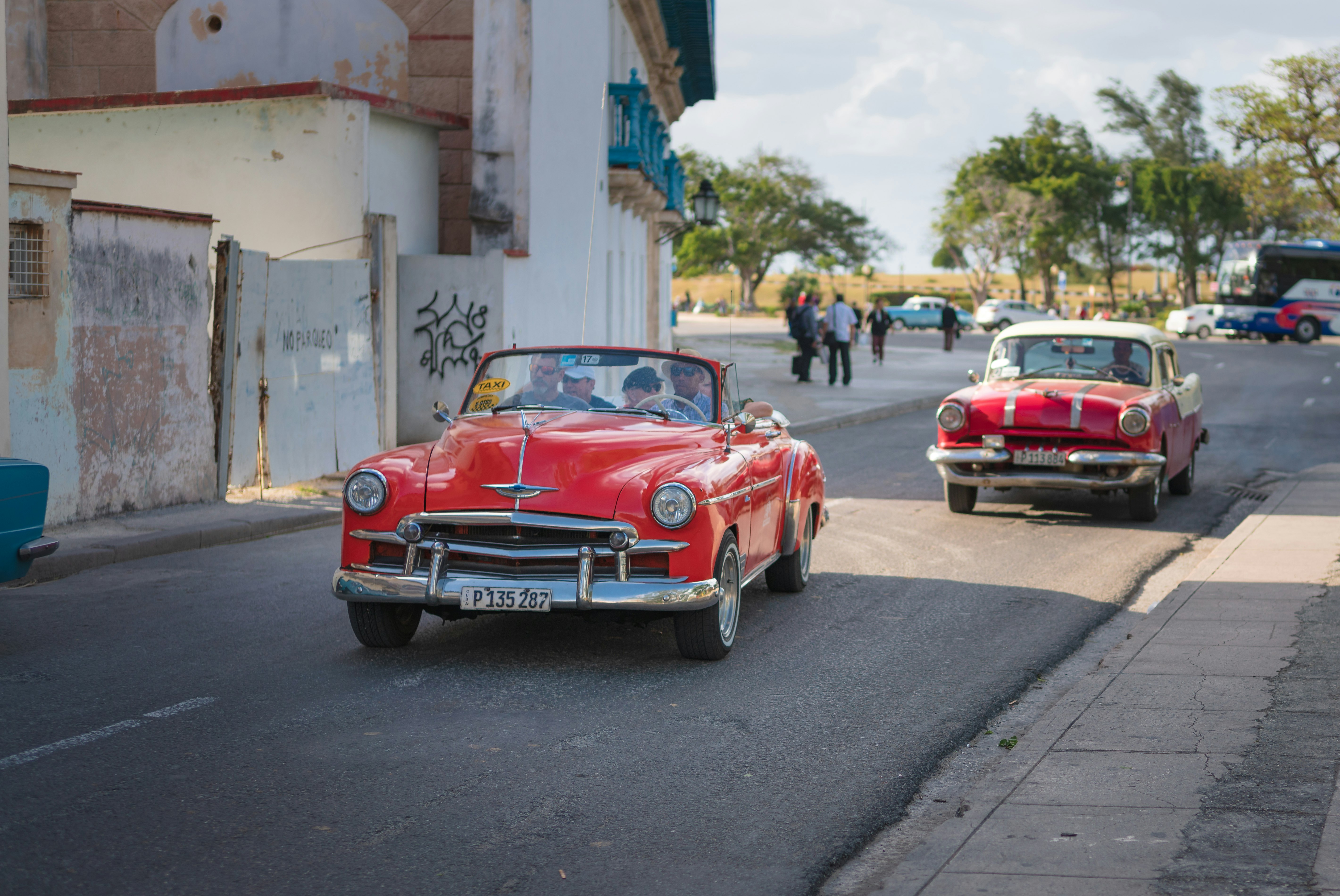 red convertible car on road during daytime