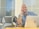 A smiling business owner reviewing a report with a laptop.