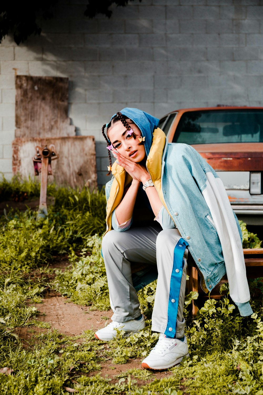 woman in white tank top and gray pants sitting on blue chair