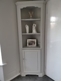 Elegant aluminium cupboard installed in a bright living room corner, blending strength and style.