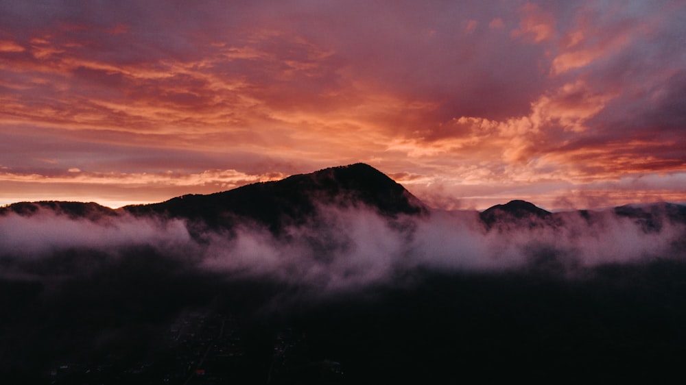 black mountain under white clouds during daytime