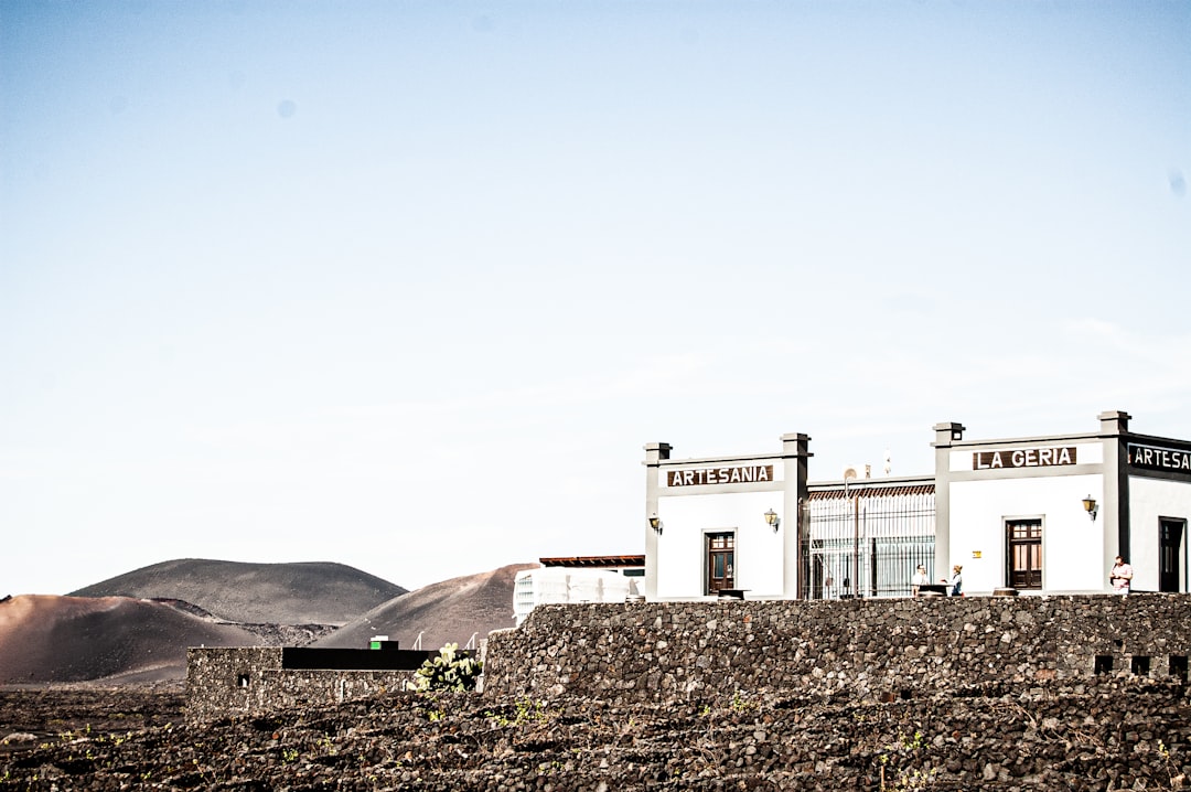 white concrete building on hill