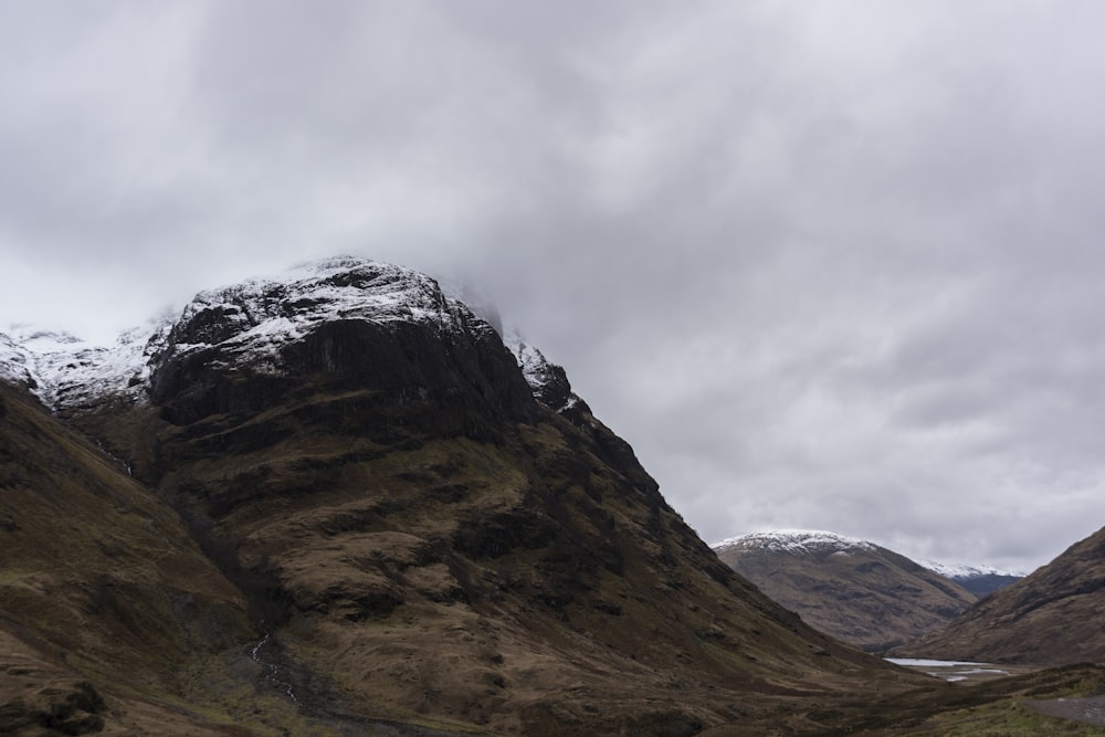 brown and gray rocky mountain under white cloudy sky during daytime