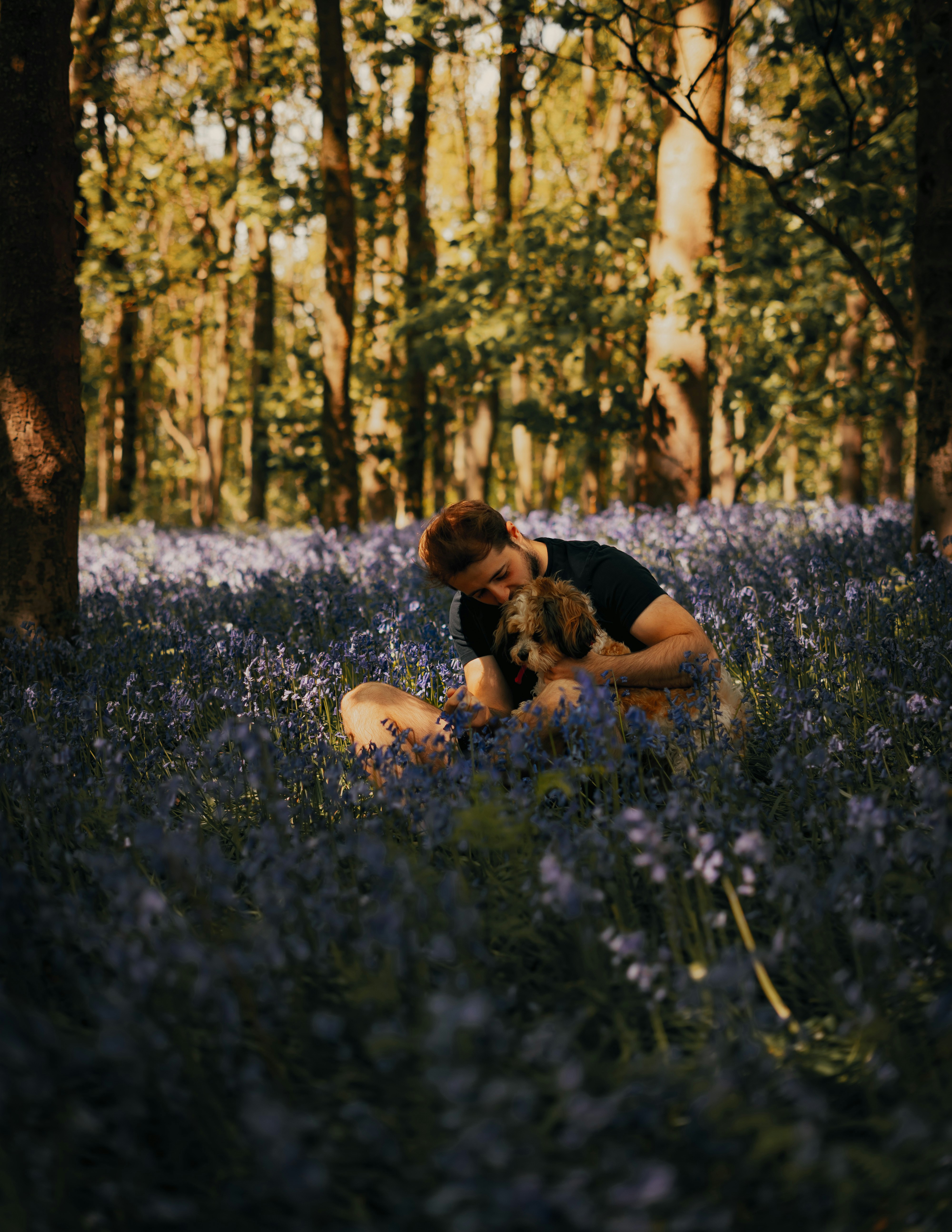 woman in black tank top lying on green grass field