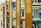 A series of wooden bookshelves filled with a variety of books organized vertically. The image captures a library setting with clear signs of academic or educational content, given the visible titles and categorization of the books.