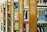 A series of wooden bookshelves filled with a variety of books organized vertically. The image captures a library setting with clear signs of academic or educational content, given the visible titles and categorization of the books.