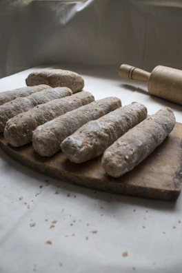 Close-up of freshly rolled dough for traditional Indian snacks on a wooden board.