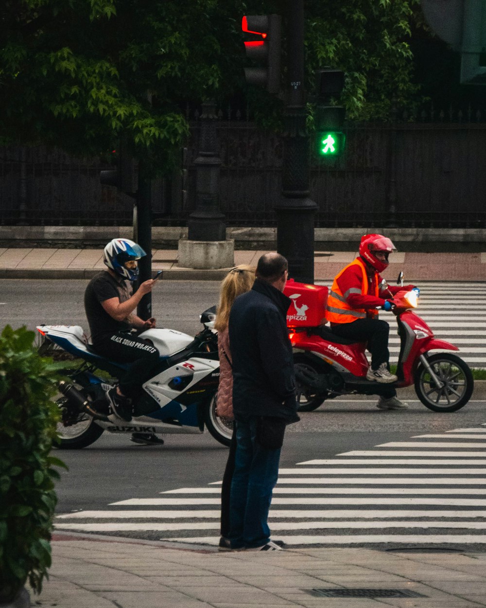 people riding on motorcycle on road during daytime