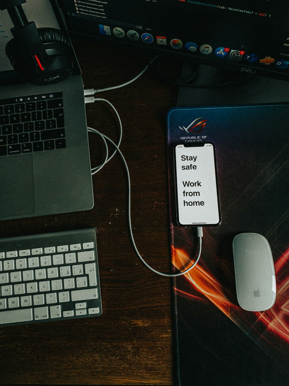 white and blue iphone case on macbook pro