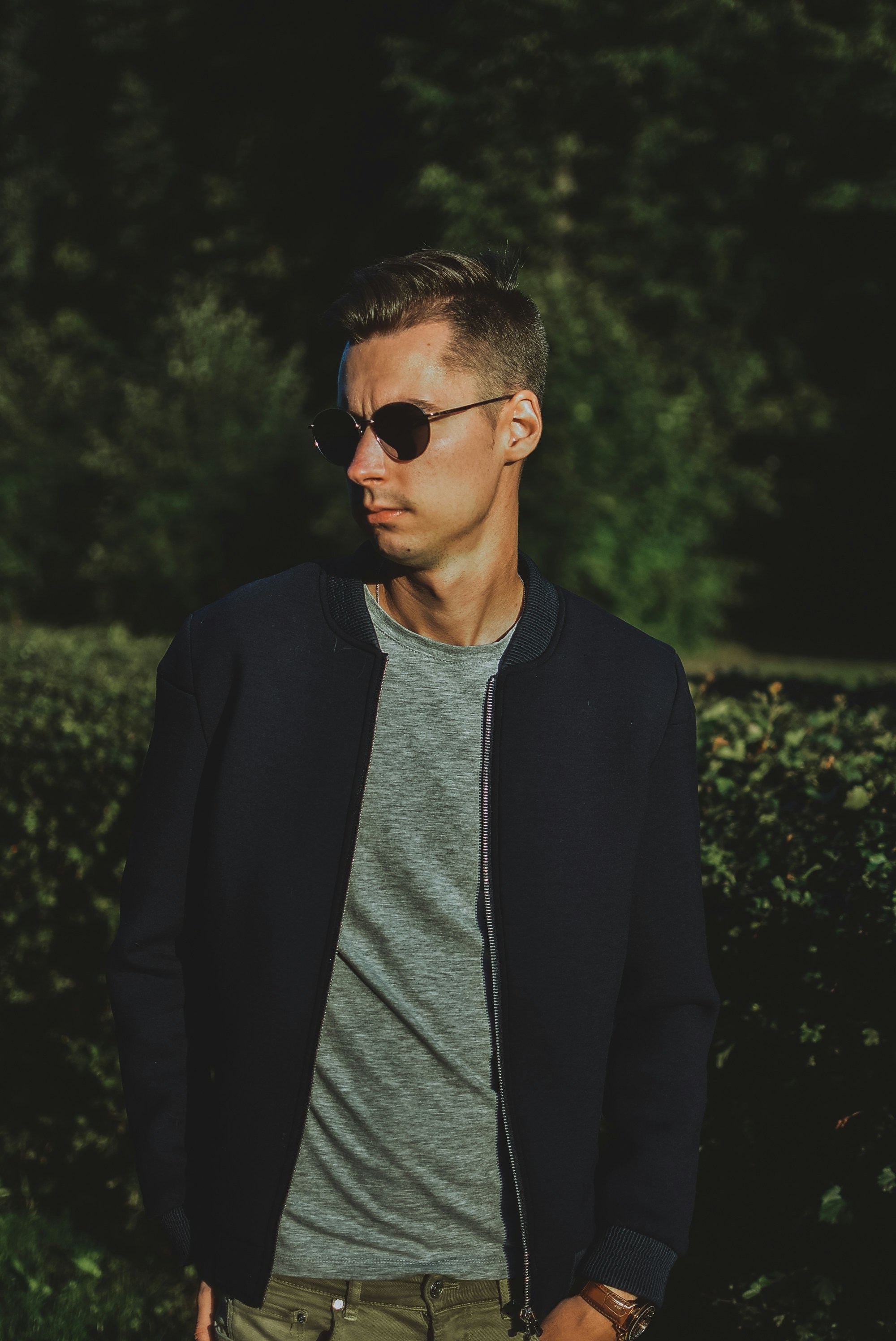 man in gray crew neck shirt and black cardigan wearing black sunglasses