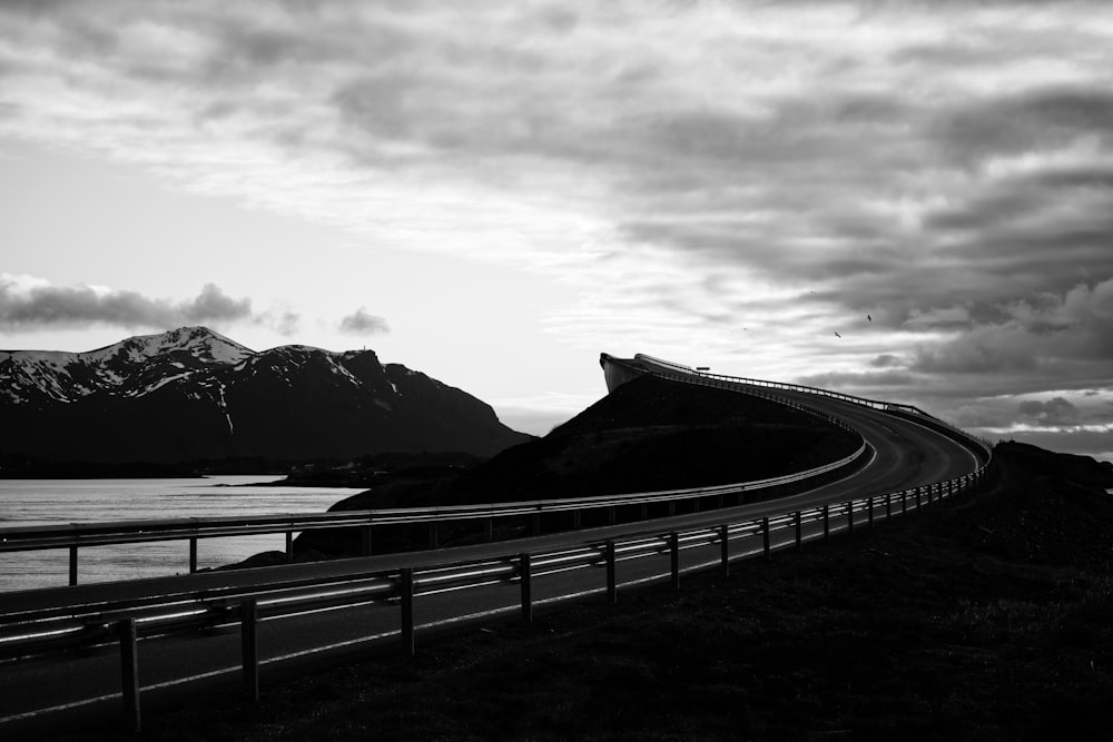 grayscale photo of bridge over the river