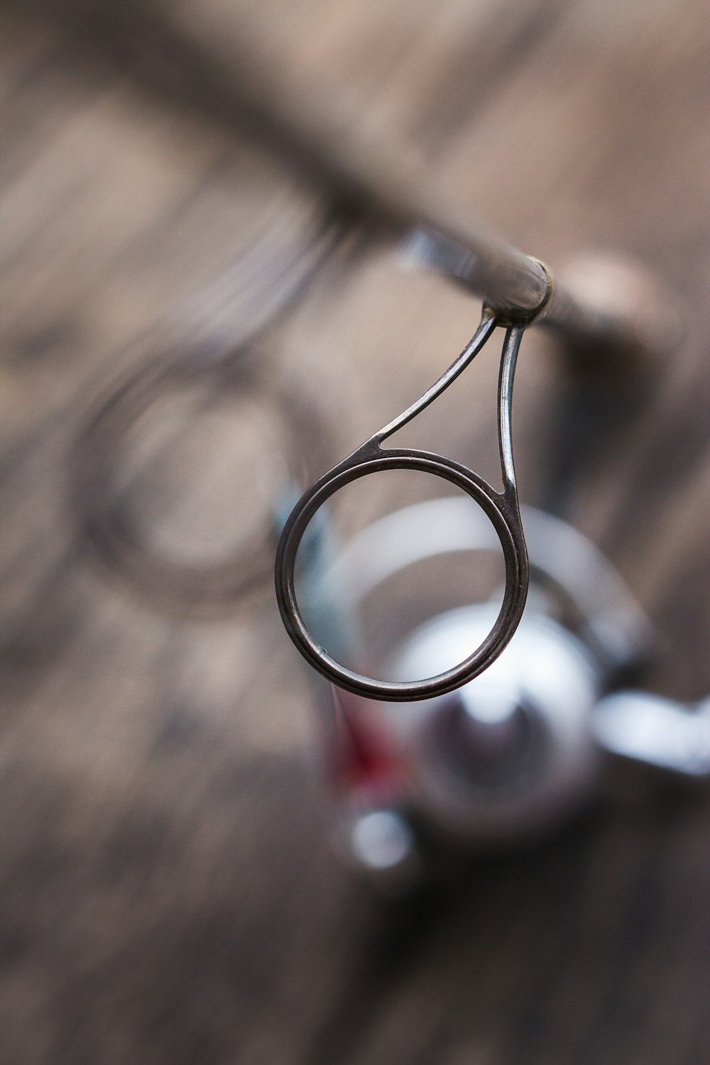 silver ring on brown wooden surface