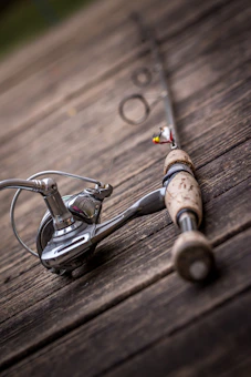 Close-up of a silver and black spinning fishing reel