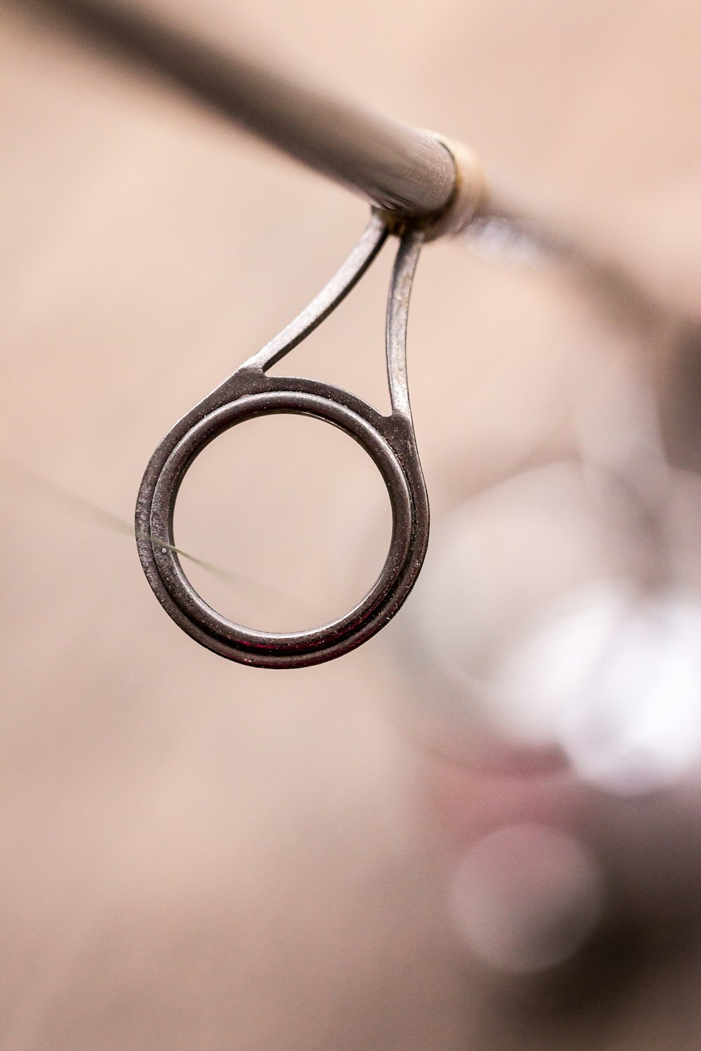 silver ring on brown metal wire