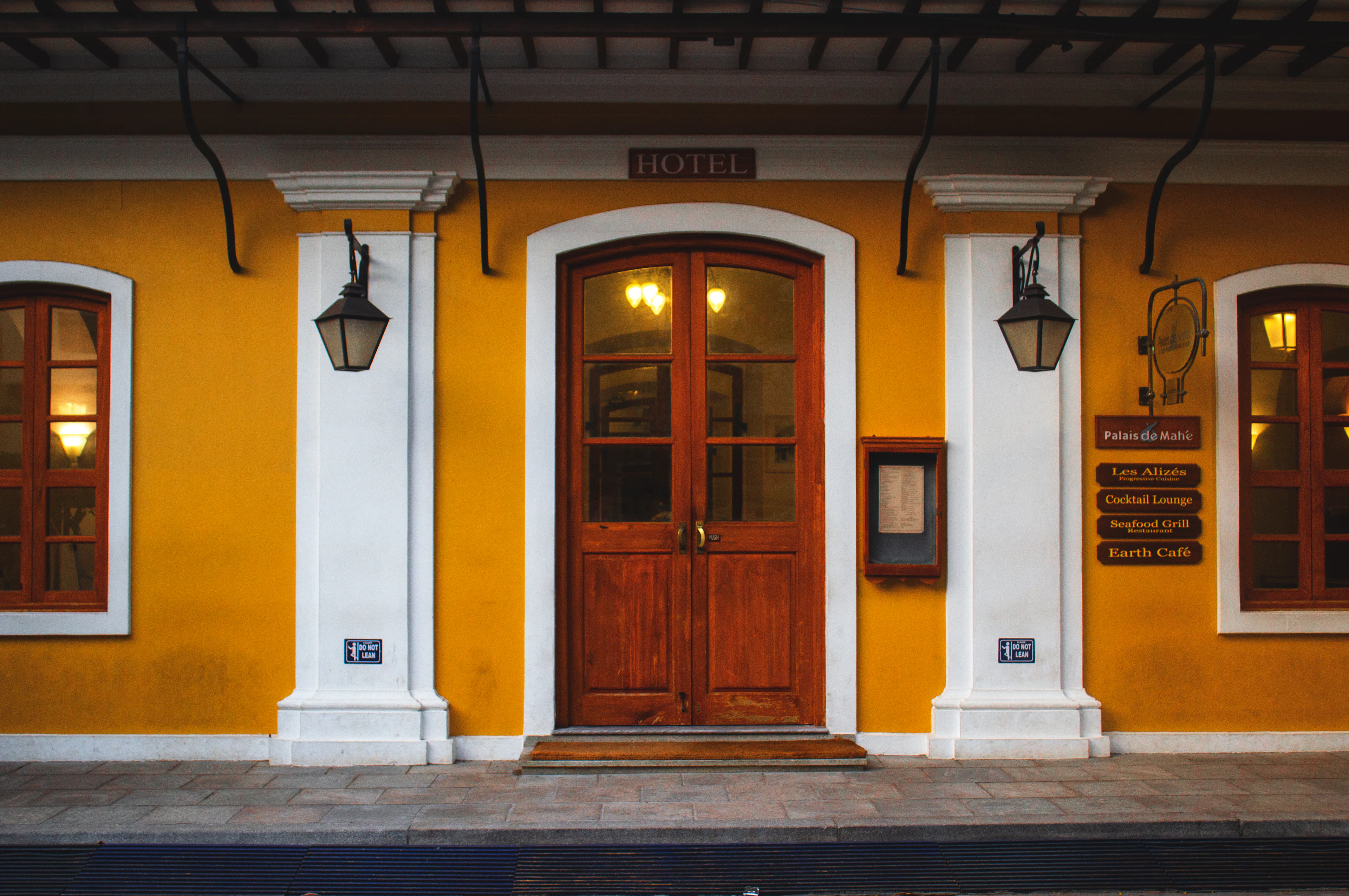A wooden door on a white wall in Puducherry