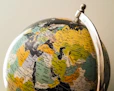 Global Visa Consultancy – blue and yellow globe symbolizing connecting people worldwide