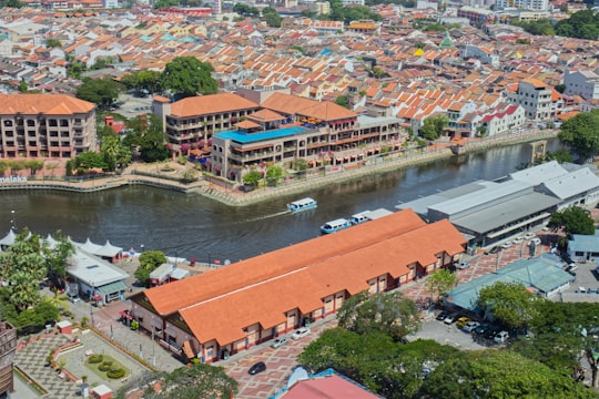 brown and white concrete buildings near river during daytime in Menara Taming Sari Malaysia