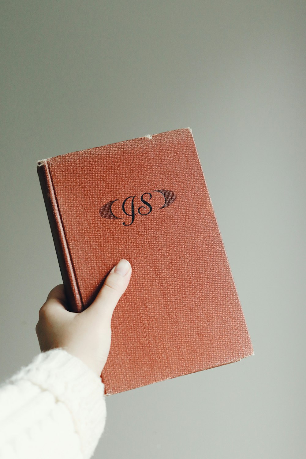 person holding brown and black box