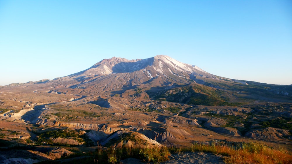 green trees and brown mountain under blue sky during daytime