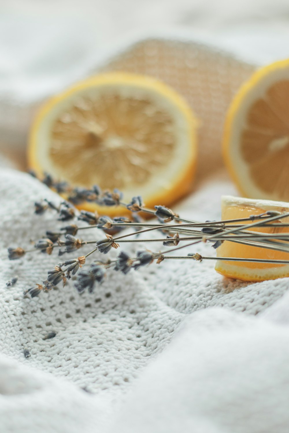 sliced orange fruit on white textile