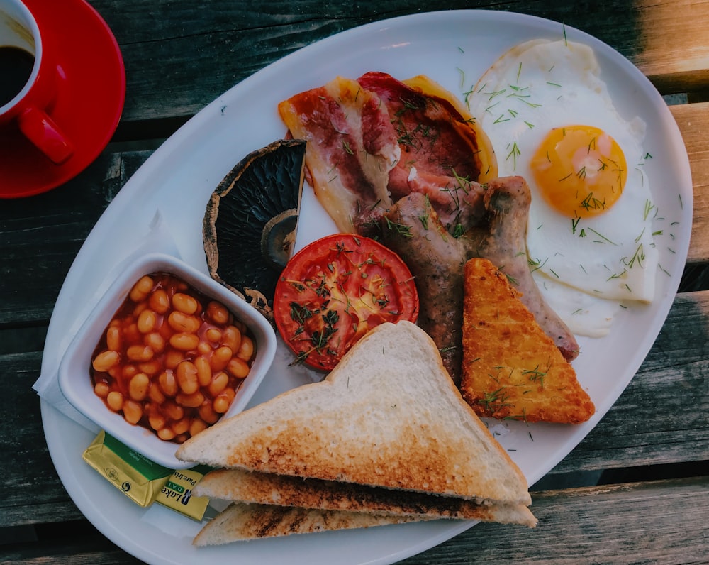 sliced meat with egg on white ceramic plate