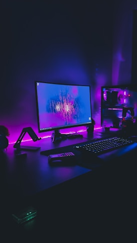 black flat screen computer monitor turned on beside black computer keyboard