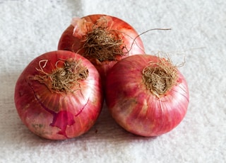 red round fruits on white textile