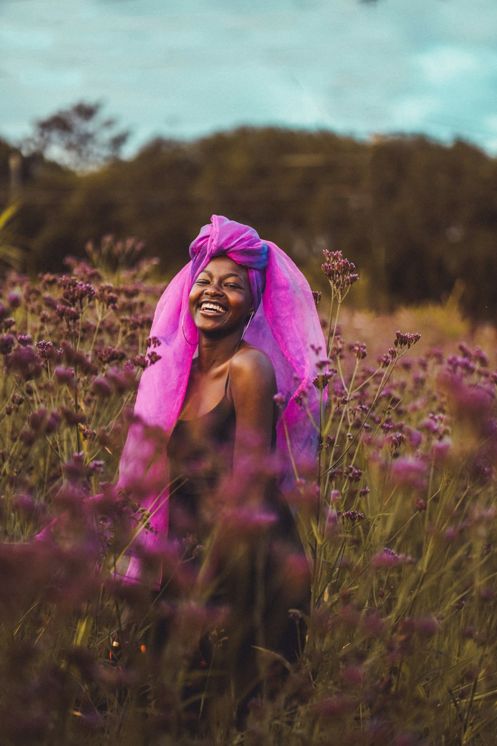 woman in purple hijab standing on purple flower field during daytime