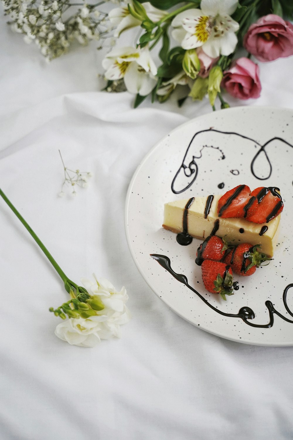 sliced tomato and green vegetable on white ceramic plate