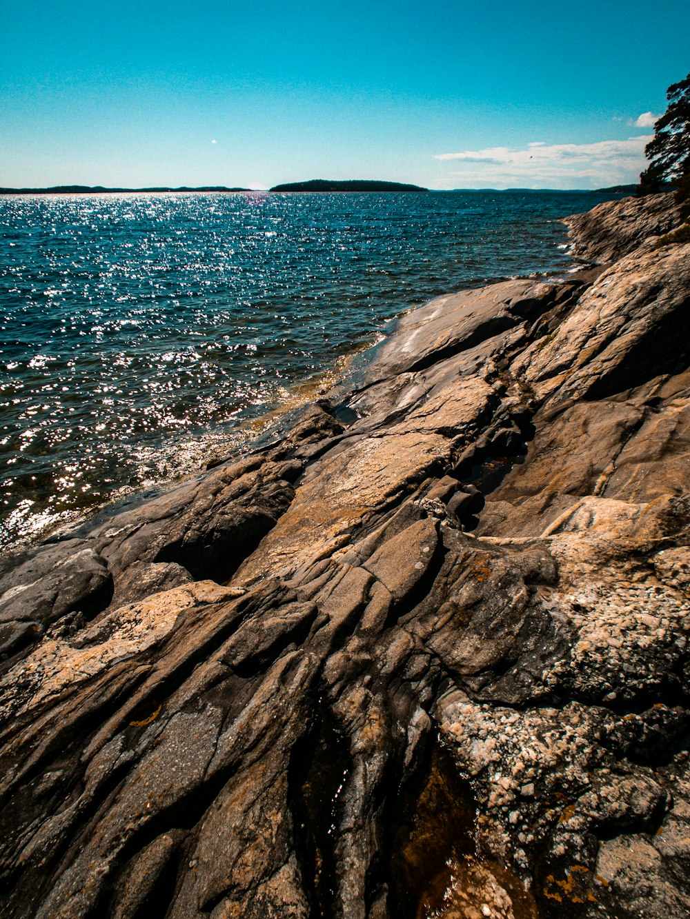 brown rock formation near body of water during daytime