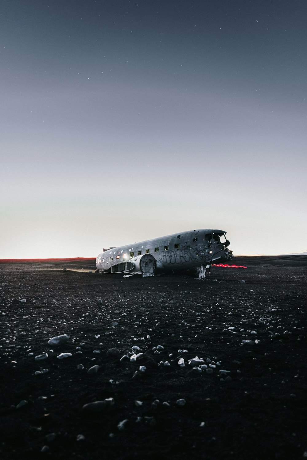 white airplane on gray sand during daytime