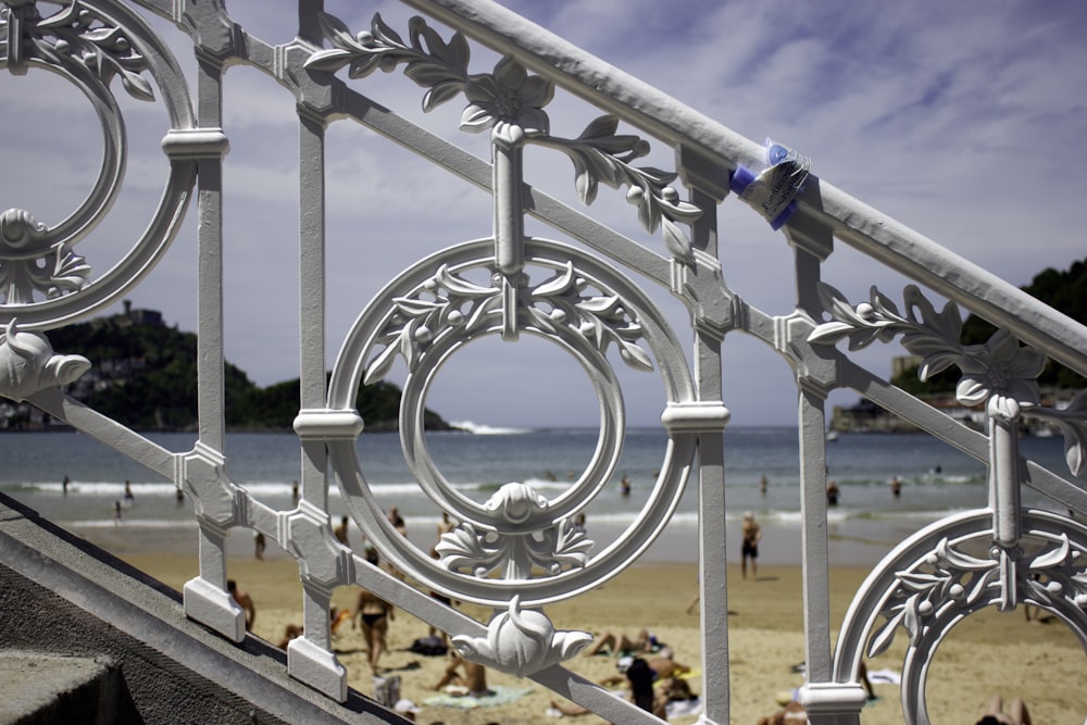 white metal railings near body of water during daytime
