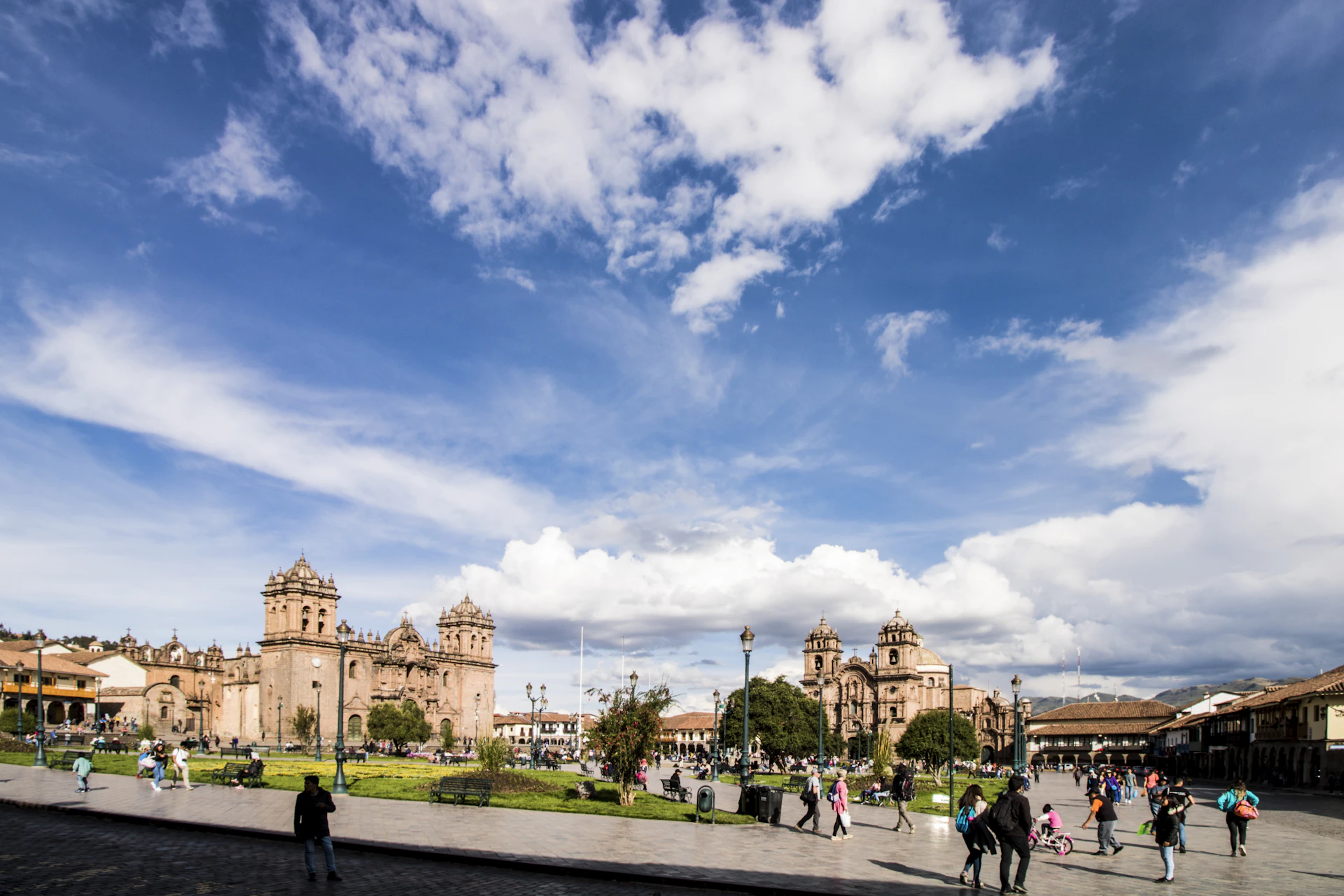 The vibrant cityscape of Cusco, showcasing its colonial architecture and bustling streets under a clear blue sky.