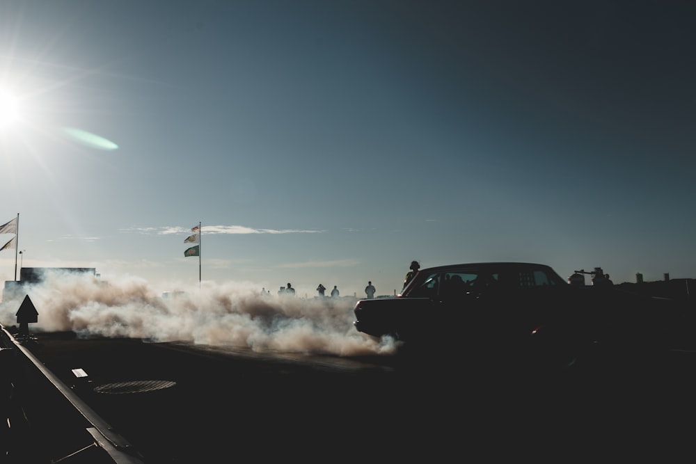 black suv on road under blue sky during daytime