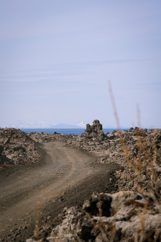 brown and gray rock formation under blue sky during daytime in Keilir Iceland