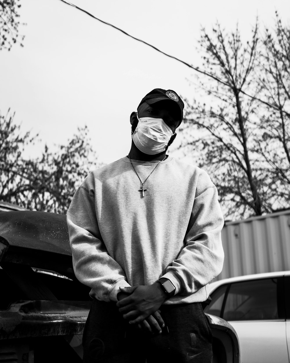 man in white hoodie wearing black sunglasses