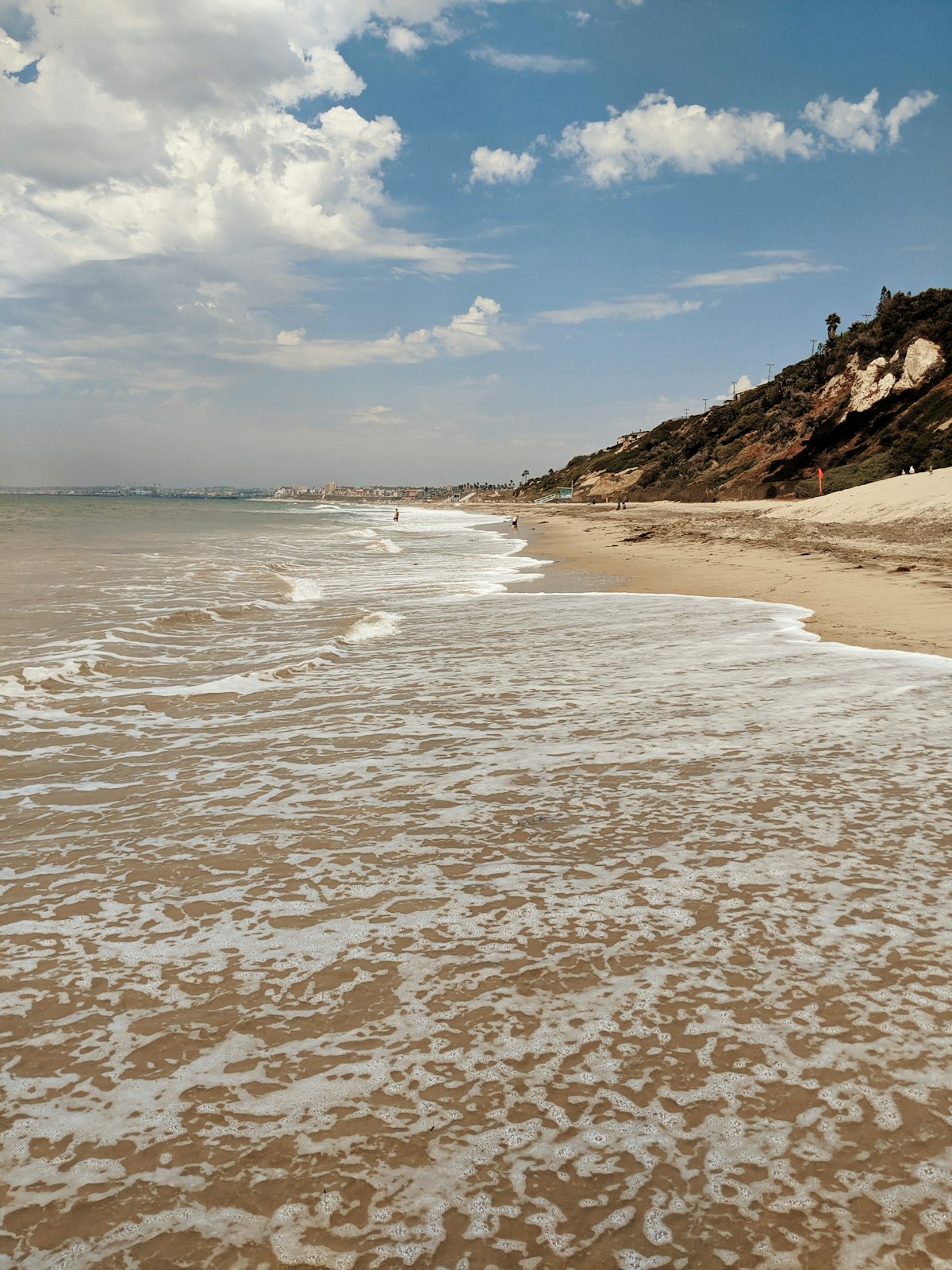 A rocky bluff along the shoreline on a clear day